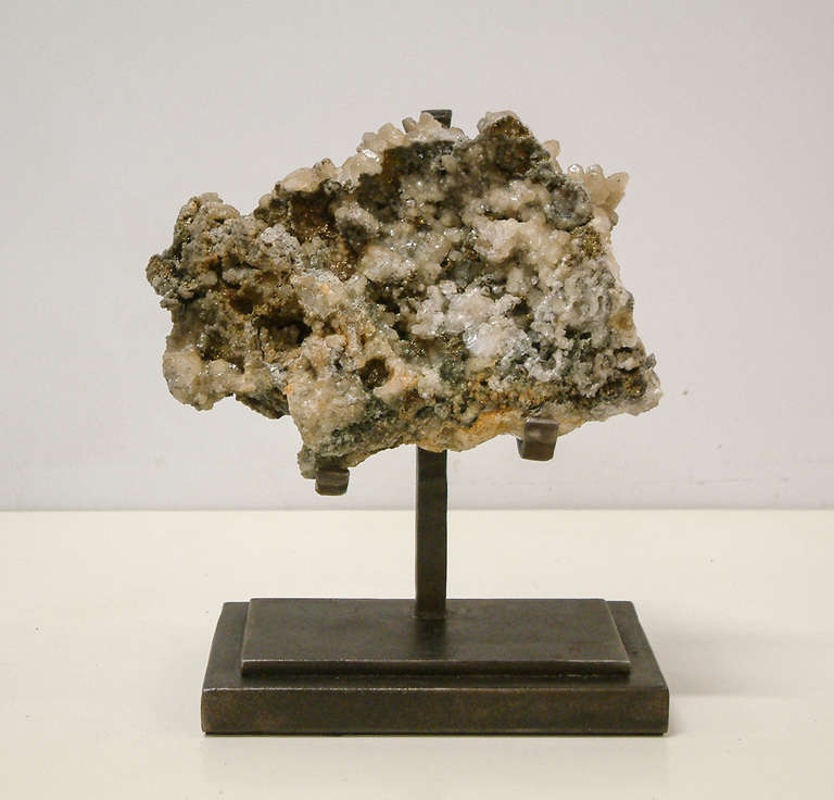 A beautiful quartz rock crystal sample with metallic coppertone deposits mounted on a custom Maurice Beane Studios stand.

Measurement:
Base 7