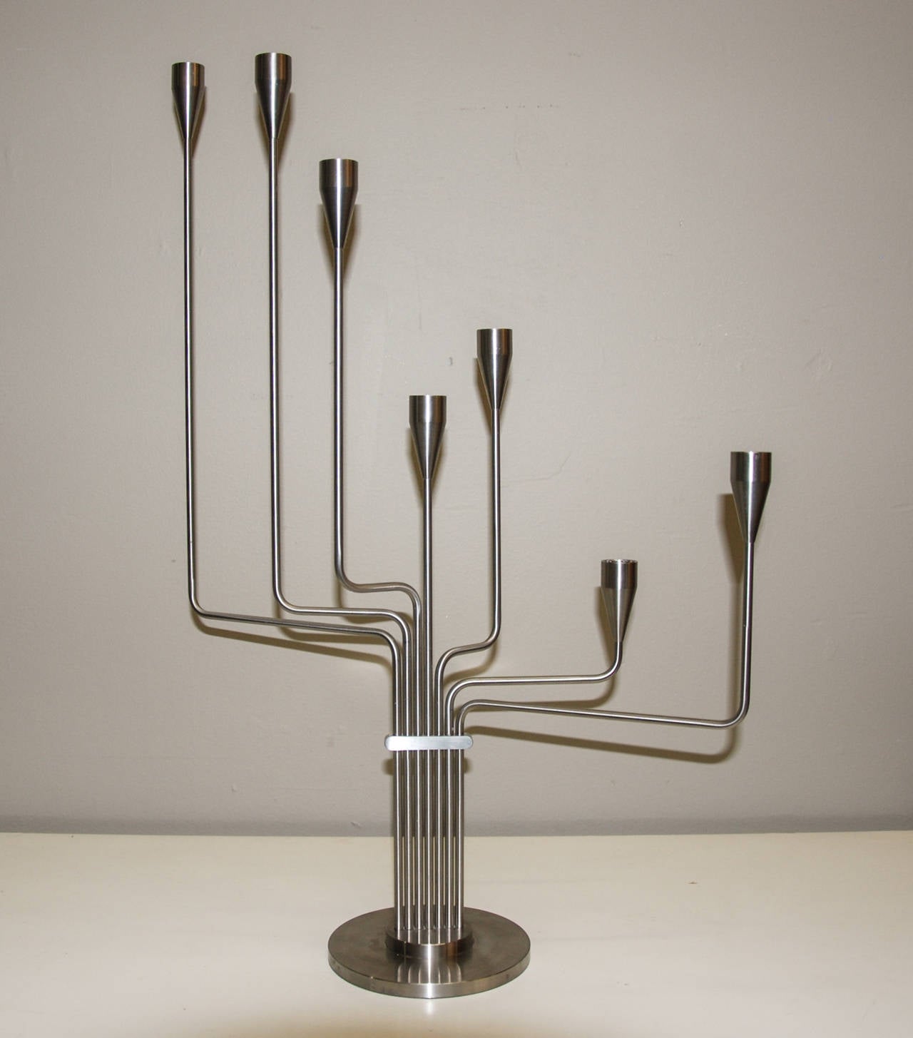 A Piet Hein articulated brushed stainless steel candelabra designed to replicate the Big Dipper of the Ursa Major constellation.  The piece is marked Piet Hein on the collar and includes seven formed bobeches.