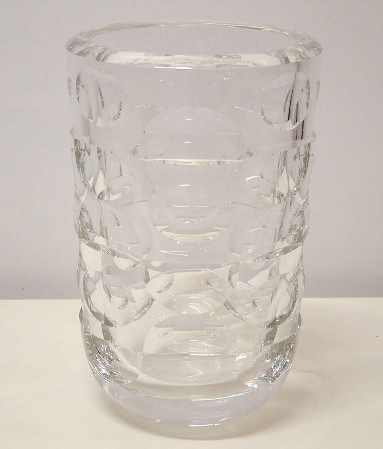 A strikingly beautiful lead crystal vase with cut-out windows of incised half and full circle alternating patterns by Orrefors of Sweden.  The vase is signed Orrefors on the base and numbered 3877-231 and is in excellent condition.  Definitely a