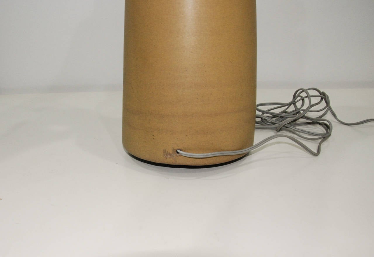 A tall ceramic and walnut lamp in original condition with the original linen shade by Gordon and Jane Martz for Marshall Studios.  Excellent condition.  Signed on the base beside the electric cord.

Measurements:
35