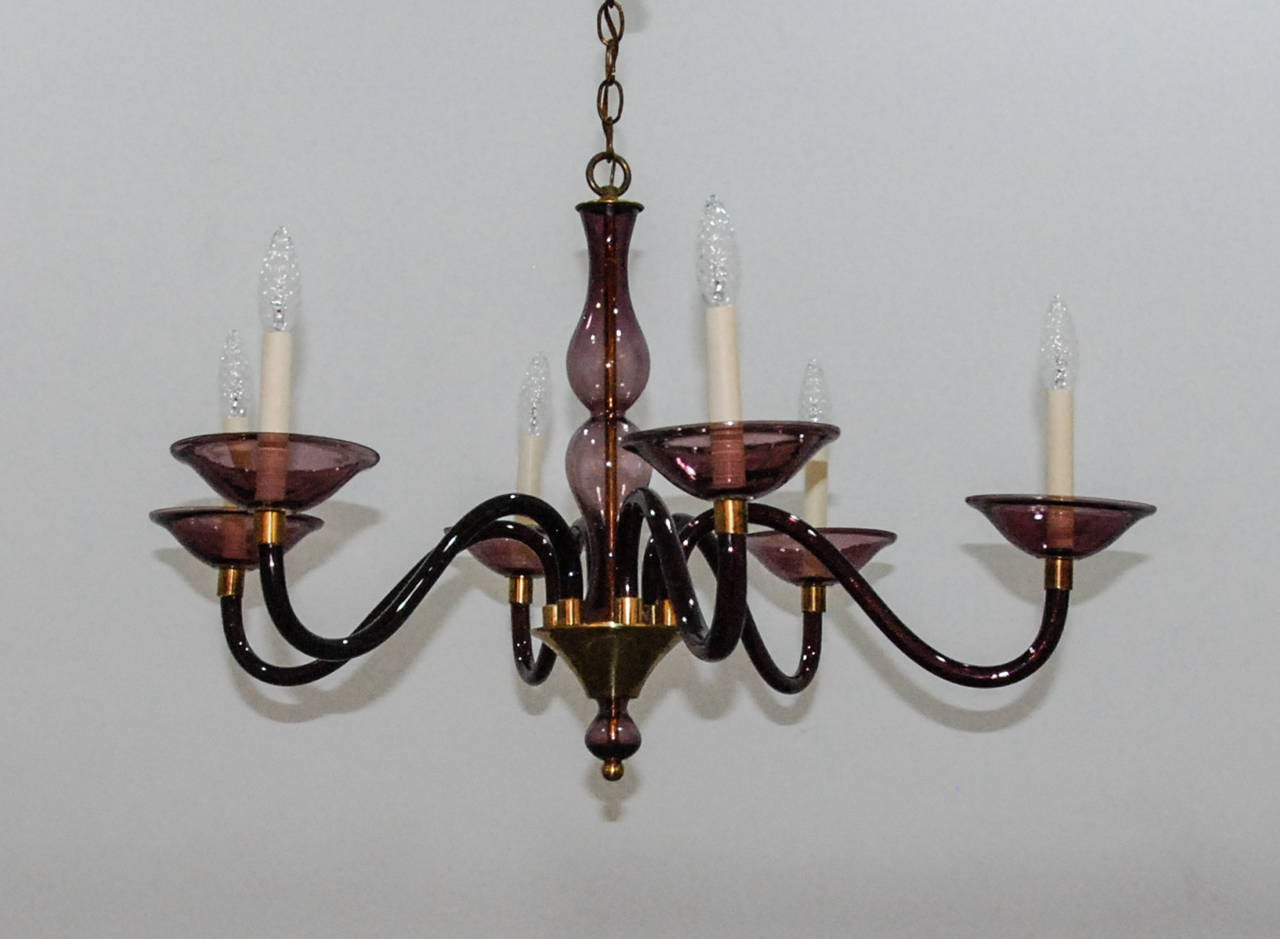 An elegant amethyst colored glass chandelier with brass fittings in the style of Pauly et Cie. All original condition with recent wiring.