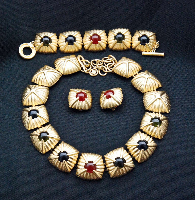 A goldtone metal and multicolor cabochon necklace, bracelet and earring set with connected panels and adjustable hook and ring clasp.  The pieces are signed Givenchy Paris / New York on an applied nameplate.

Bracelet: 7.88