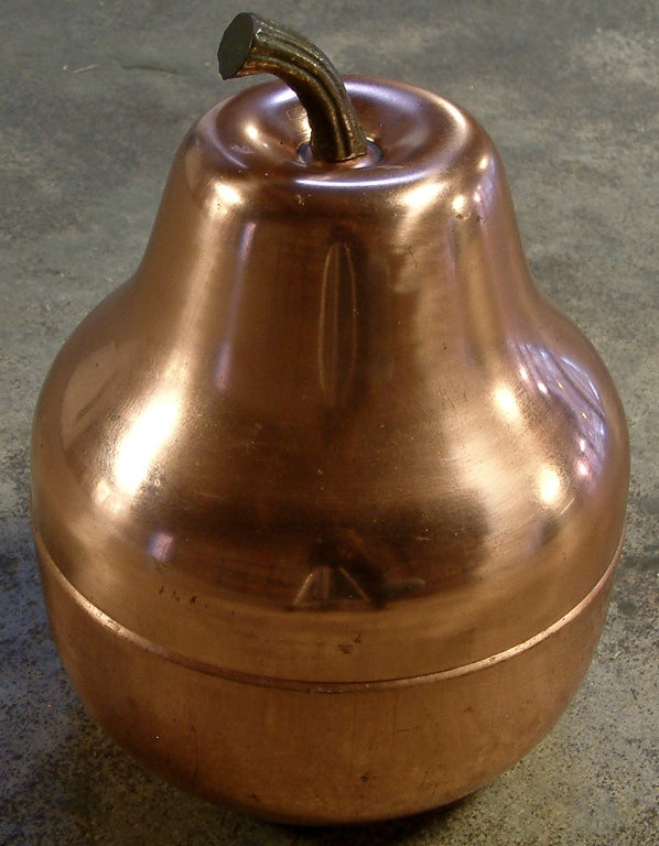 A whimsical copper pear ice bucket with a plastic liner made in Italy and imported by Raymor.  The stem of the pear is cast of solid bronze.