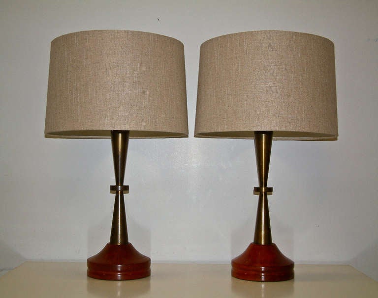 A stunning pair of machined bronze lamps with a primavera wood base with the original patina.  New wiring with replaced tan linen drum shades.

22.58