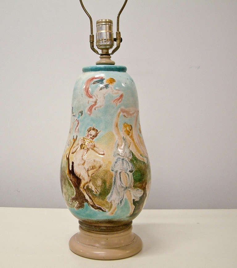 A rare ceramic lamp depicting nymphs and satyrs by master sculptor and potter Professor Eugenio Pattarino.  He maintained a studio in Florence, Italy and in the 1950's employed more than 50 artisans.  Pattarino is best known for his religious and