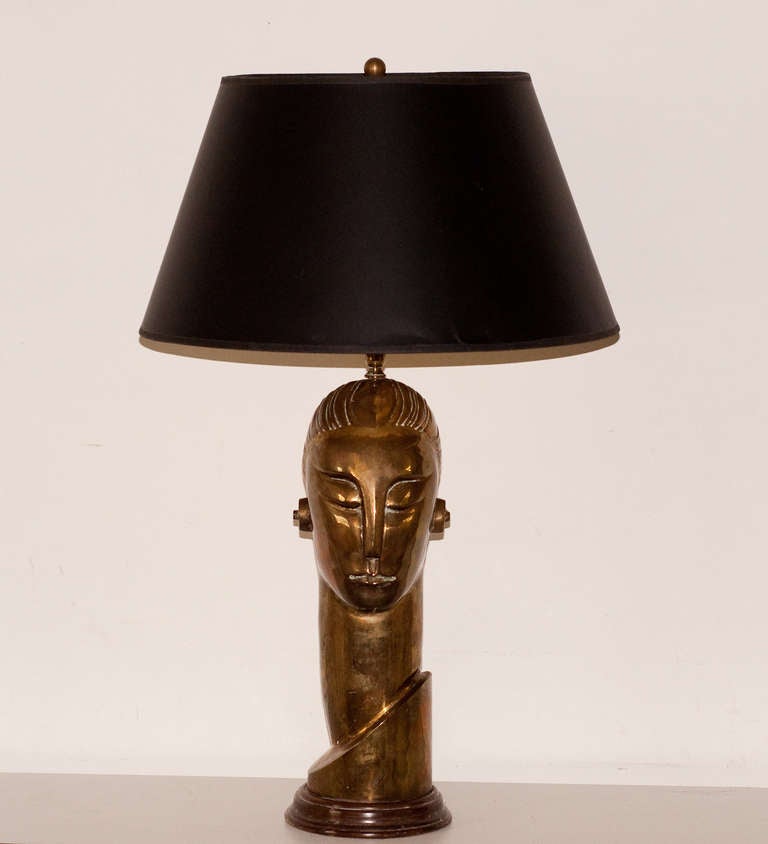 A stunning Art Deco style cast brass head lamp somwhat reminiscent of the robot in Fritz Lang's epic film 