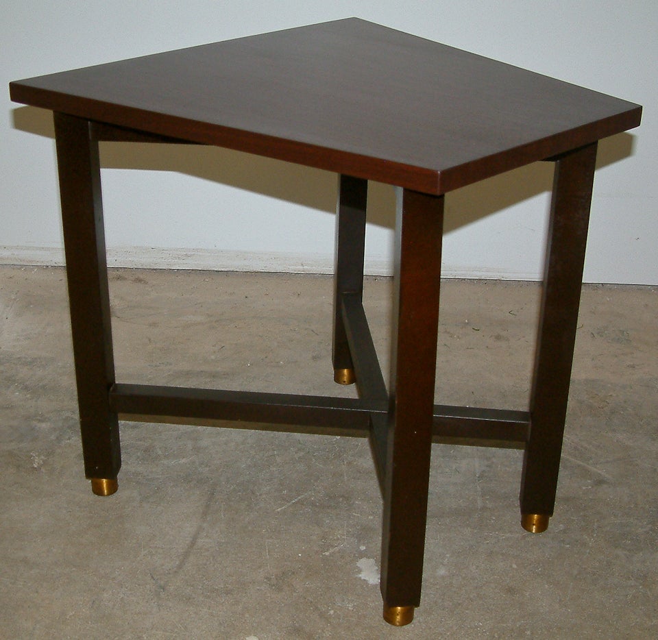 A Dunbar wedge shaped occasional table with brass capped legs complete with the metal Dunbar contract label.  A new walnut veneer top has replaced the original wood grain formica top.  A definite improvement on the original design.