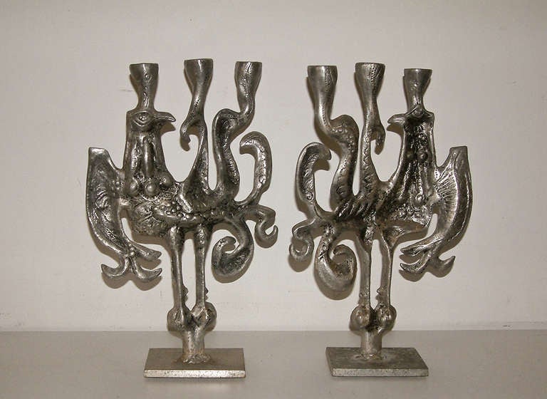 A sculptural pair of aluminum candleholders by noted Akron, Ohio sculptor Donald Drumm.  The cast aluminum candleholders are highly abstracted, very textured and retain the original finish.