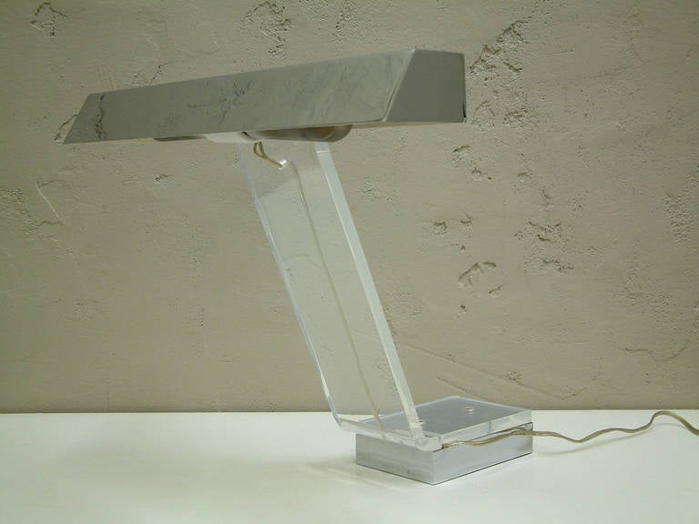 A unique cantilevered steel and lucite desk lamp of superior quality from the 1970s.  All original components.