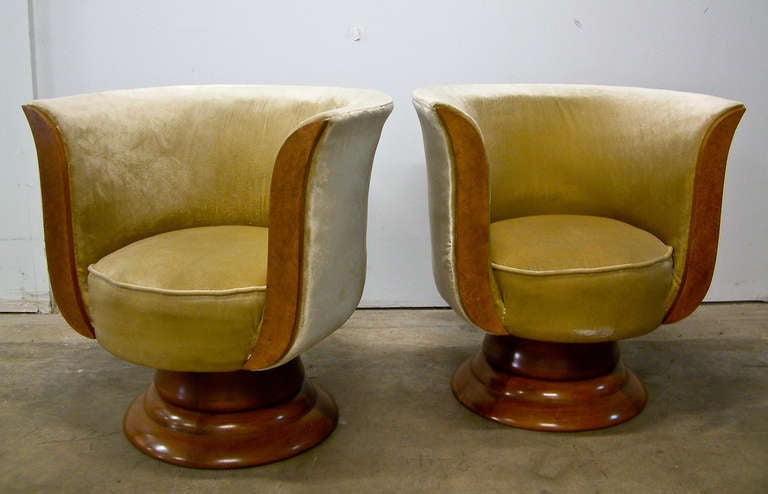 A stunning pair of burl wood and velvet art deco lounge chairs designed in France and manufactured in Japan for Hotel Le Malandre in Belgium in the 1930's.  The chairs have a 360 degree swivel mechanism and were probably recovered in a tan velvet in