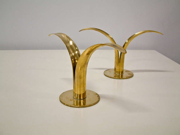 A dramatic grouping of brass lily form candleholders made in Sweden of two varing heights.  Each candleholder is stamped on the base with the manufactures name, monogram and country of origin.  Varying degrees of patina.

Small:  4.13