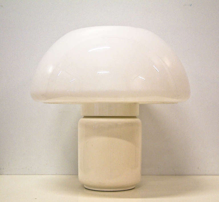 A large Martinelli Luce table lamp made in Italy in the form of a mushroom. The dome shade is opaque white plastic and the base incorporates a three socket fixture with a round on/off switch on a white enameled steel cylinder. The lamp base includes