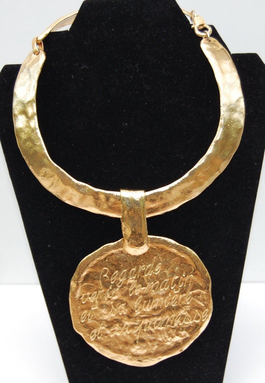 A very large goldtone necklace by Cecile & Jeanne with a removable medallion inscribed in French saying 