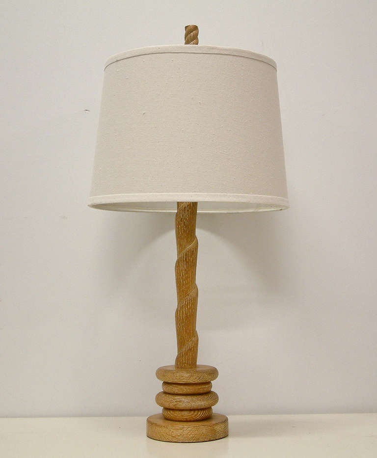A sculptural lathed and carved cerused oak lamp on a multi-tiered base from the forties.

Measurements:

28.88