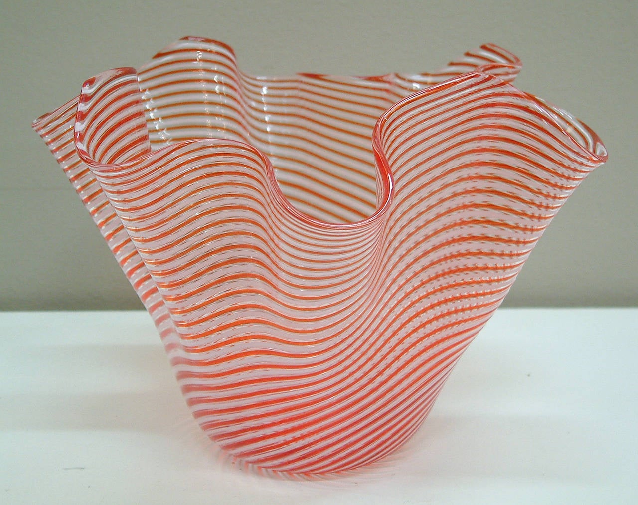 A beautiful candy cane striped Murano handkerchief vase by the glass factory of Fratelli Toso handblown in the 1950s.  The piece has a ground and polished pontil.  Perfect for the holiday table!