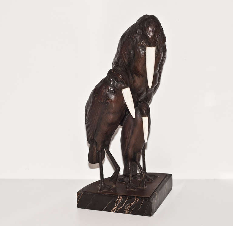 A stylized trio of bronze and bone Marabou Storks of the Art Deco period mounted on a black and gold marble base.  The stylization of the birds is reminiscent of the work of French sculptor Marcel Bouraine.

Measurements:
Base .75