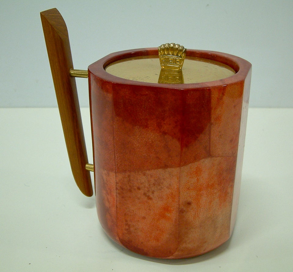 A stunning red-dyed parchment lidded ice bucket with walnut handle, brass finial and glass insulated liner.