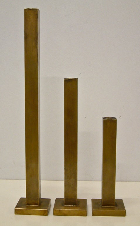 A very streamlined and minimalist trio of bronze candleholders by Canadian designer Martha Sturdy.  The candleholders have a Martha Sturdy brass nameplate and were retailed by Bergdorf Goodman New York.