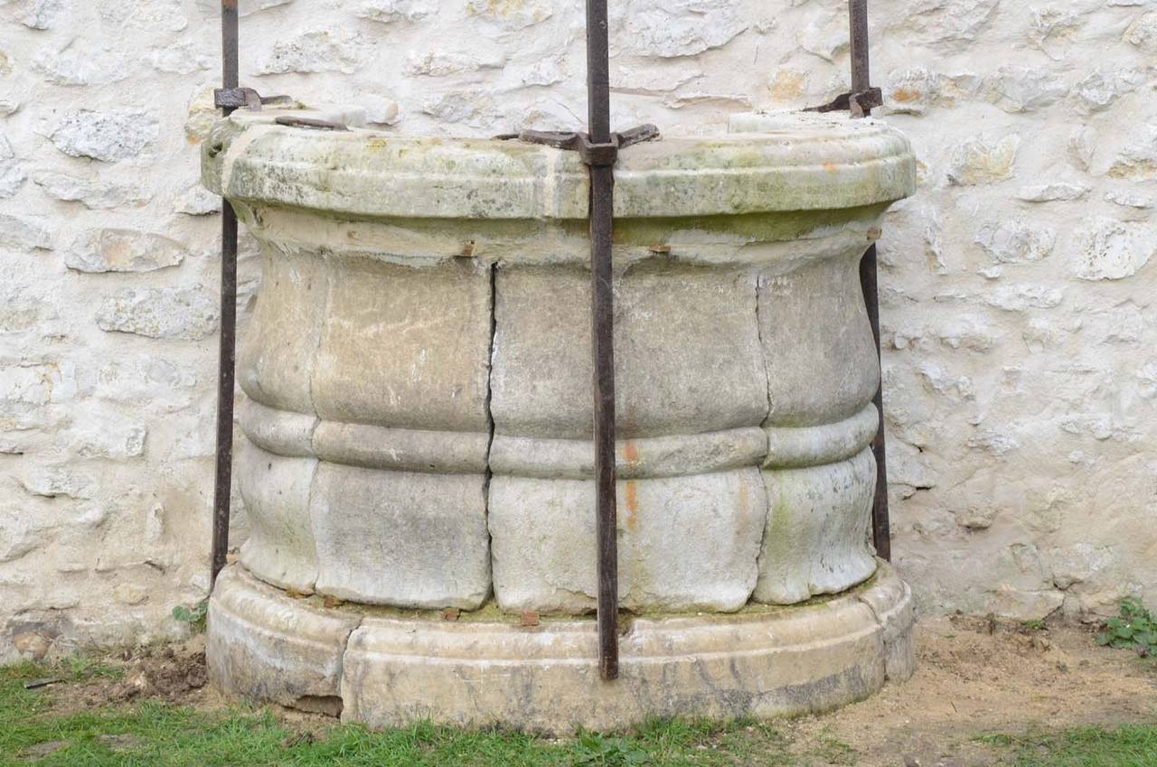 French Louis XIV period stone and wrought iron well curbstone.