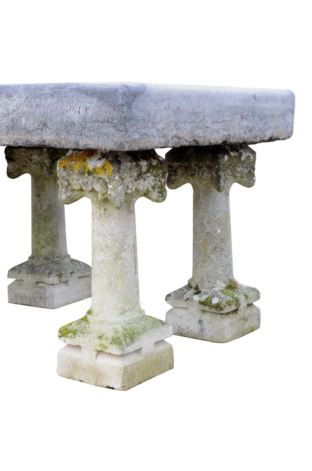 Important garden table maded of reclaimed architectural elements: monolithic blue stone tabletop and six French Art Nouveau period composite stone columns. # E6562.