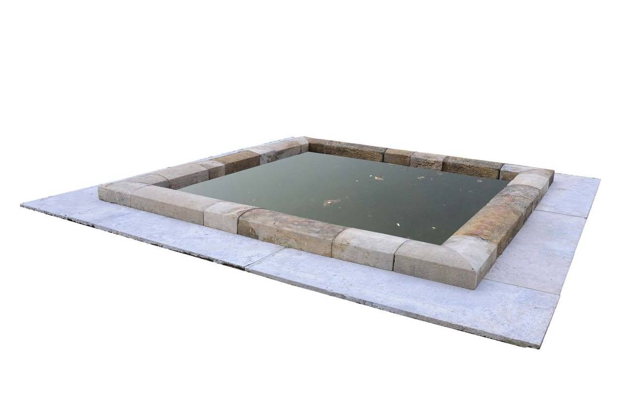 Stone basin made of architectural reclaimed elements. Maximum width and length with the large stone slabs : 170 x 170 in. Each stone slab: 71 x 28 in. # E6565.