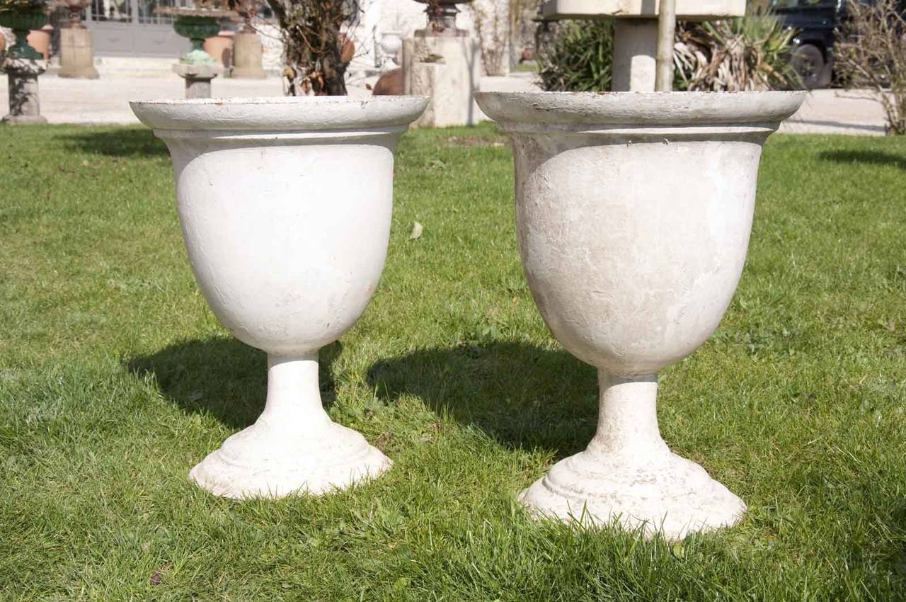 A pair of cast iron vases dated late 19th century. # E6199.