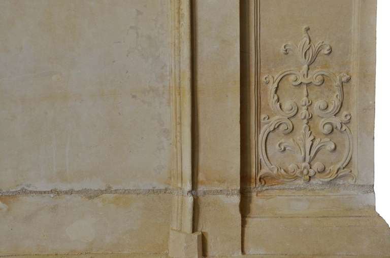 A rare Louis the 14th period richly carved limestone fireplace, with a trumeau, dated early 18th century. Minor restorations, lintel reinforced. Origin : Normandy - Falaise. Opening : 40 in. H. - 49 in. W. # C3282.
