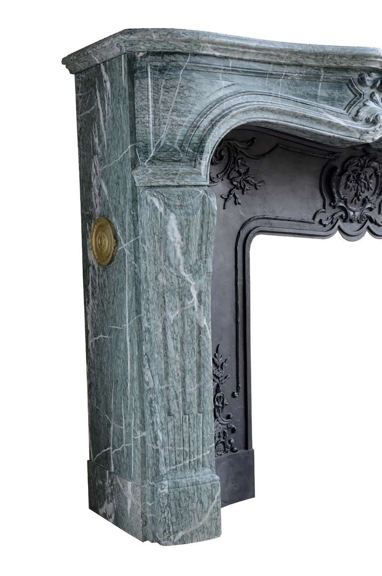 French Louis the 15th style green marble fireplace and its cast iron reduction. Marble named Campan Vert.  Opening at the cast iron reduction : 28 x 31 in. Marble front floor : 63 x 15 x 2 in. # C3406.