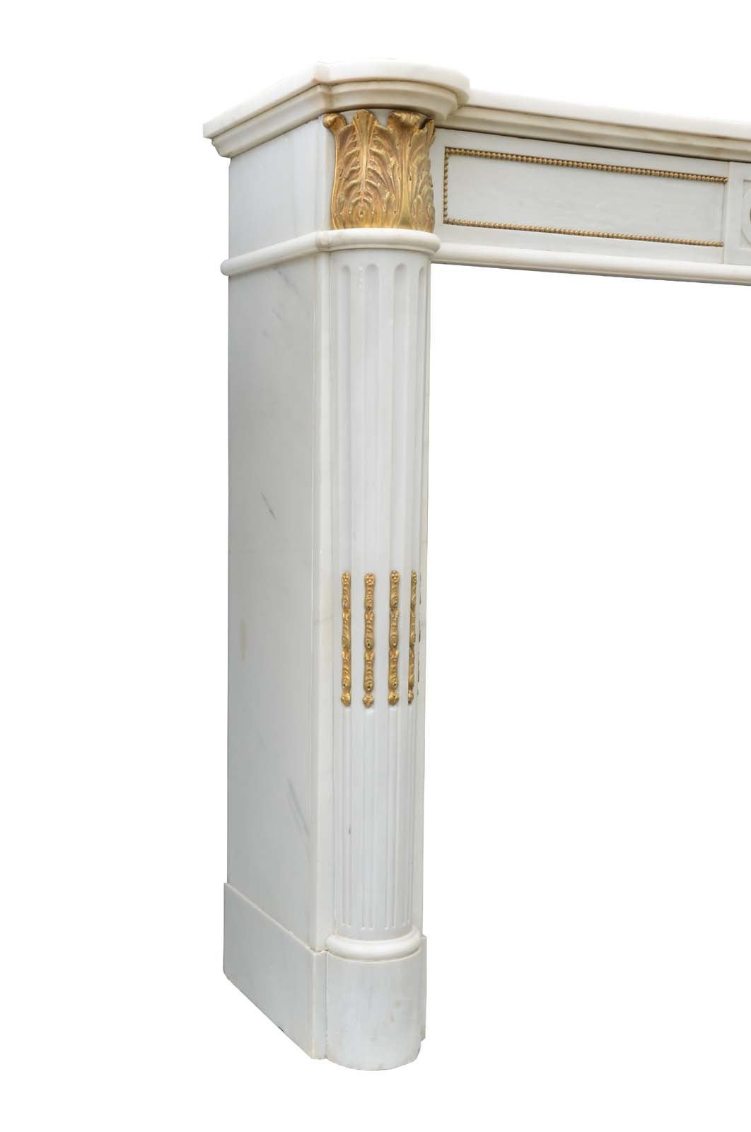 French Louis XVI style white marble and gilded bronze fireplace dated late 19th century. Dimensions: Opening: 35 x 44 in.
