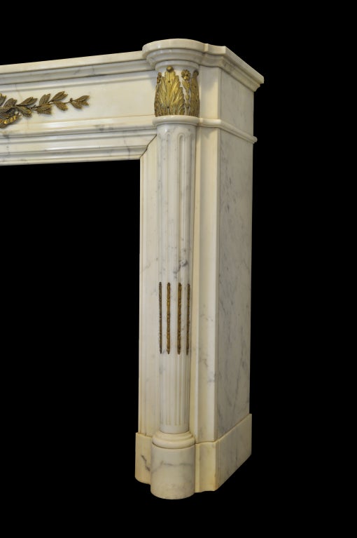 A French Louis the 16th style white marble and gilded bronze fireplace dated late 19th Century. # C3256.