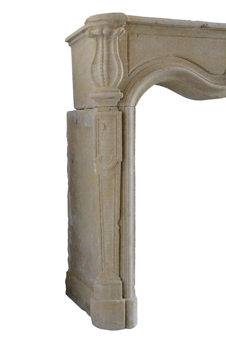 French Louis XV period limestone fireplace dated 18th century. Opening: 43 x 49 in.