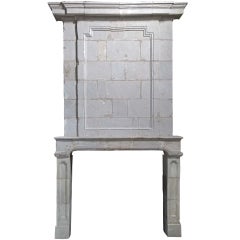 Antique A French Louis the 14th period limestone fireplace.