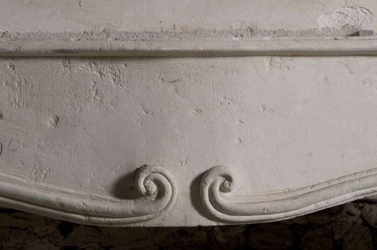 French Louis the 14th period limestone fireplace. Early 18th Century. Restored. Origin : Charente. Opening : 43 in. H. - 51 in. W. # C2328.