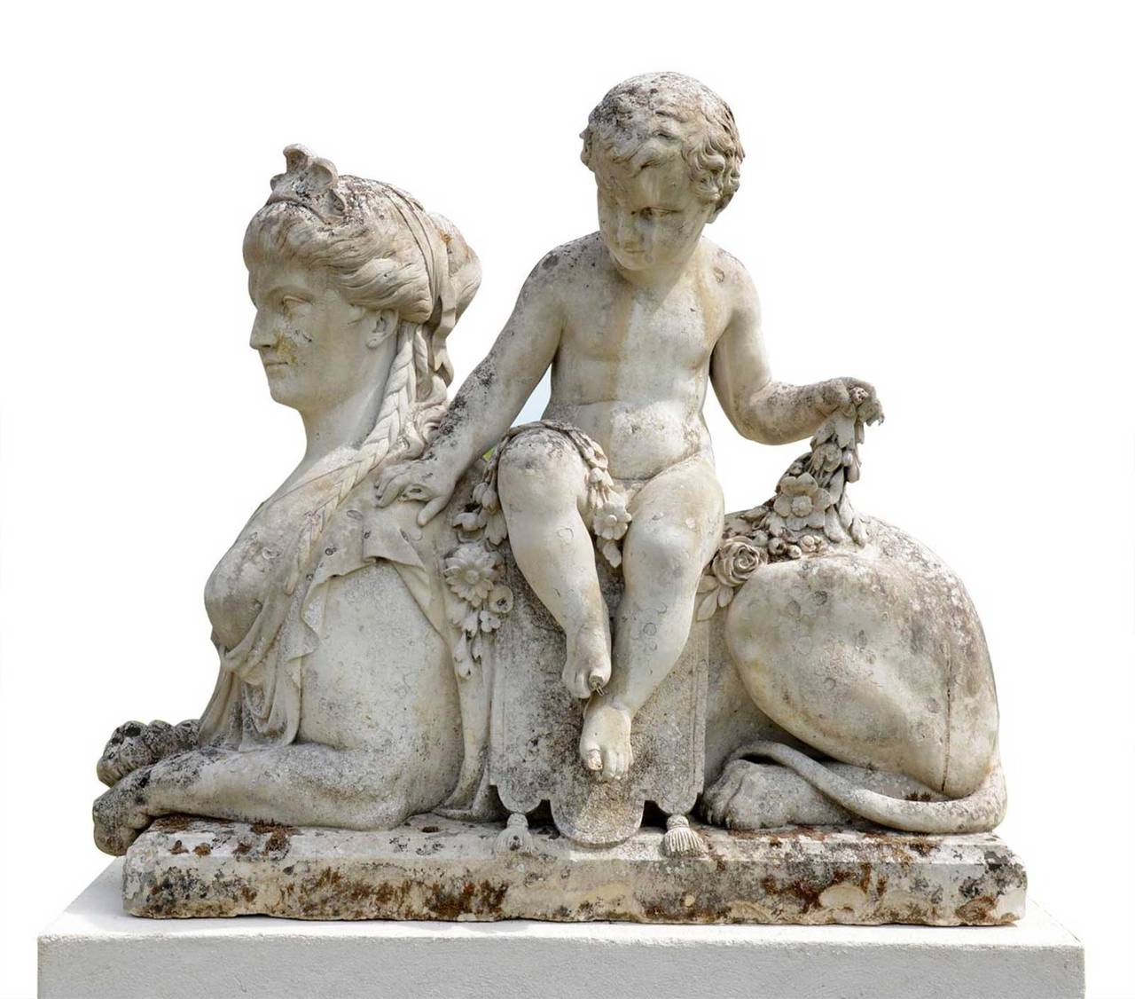 Exceptional and imposing pair of Saint-Maximin stone sphinxes, each being astride by a cherub holding a flowered garland. Made during the first half of the 19th century. These Sphinges are a reinterpretation of several famous models in which groups