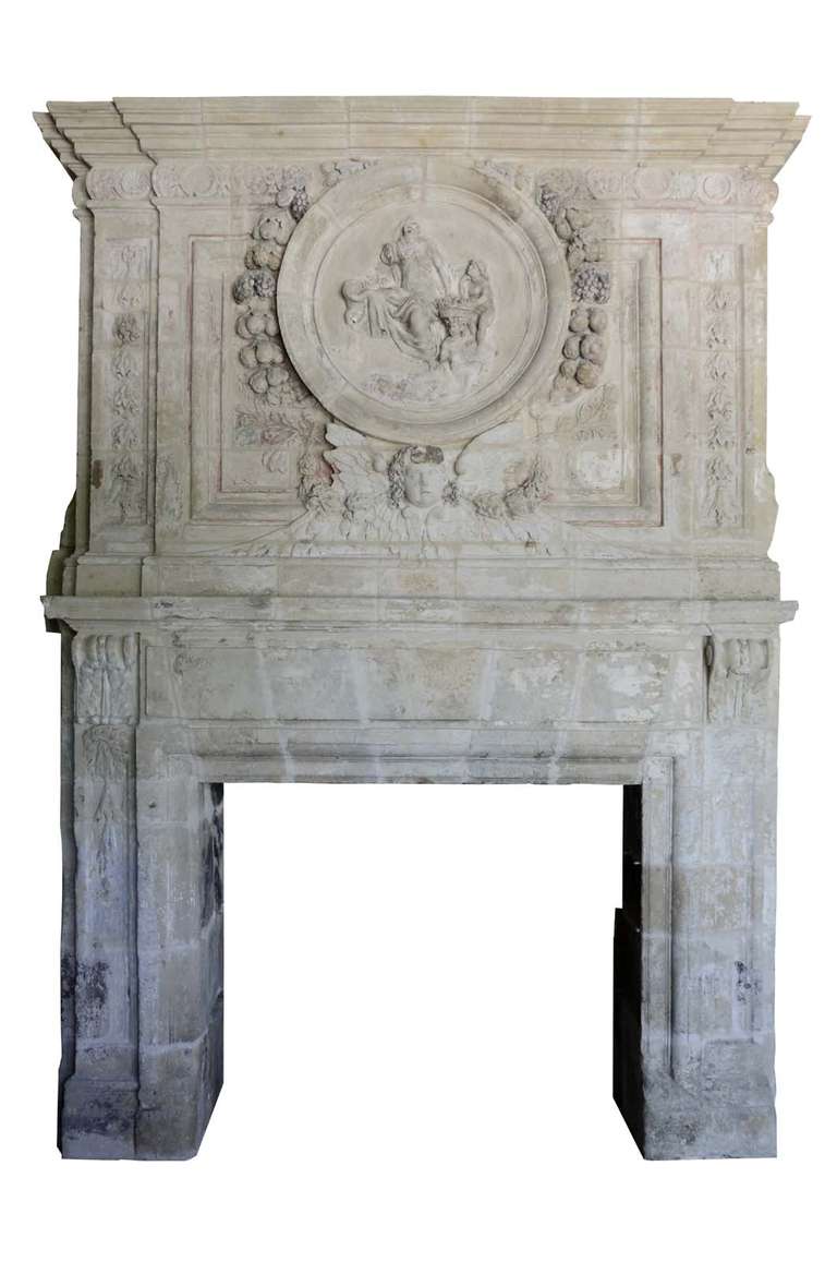 French Louis XIV period carved and painted stone fireplace dated 17th century. Little accidents and losses. Origin : Igé (Orne). Opening : 48 x 58 in. # C3398.