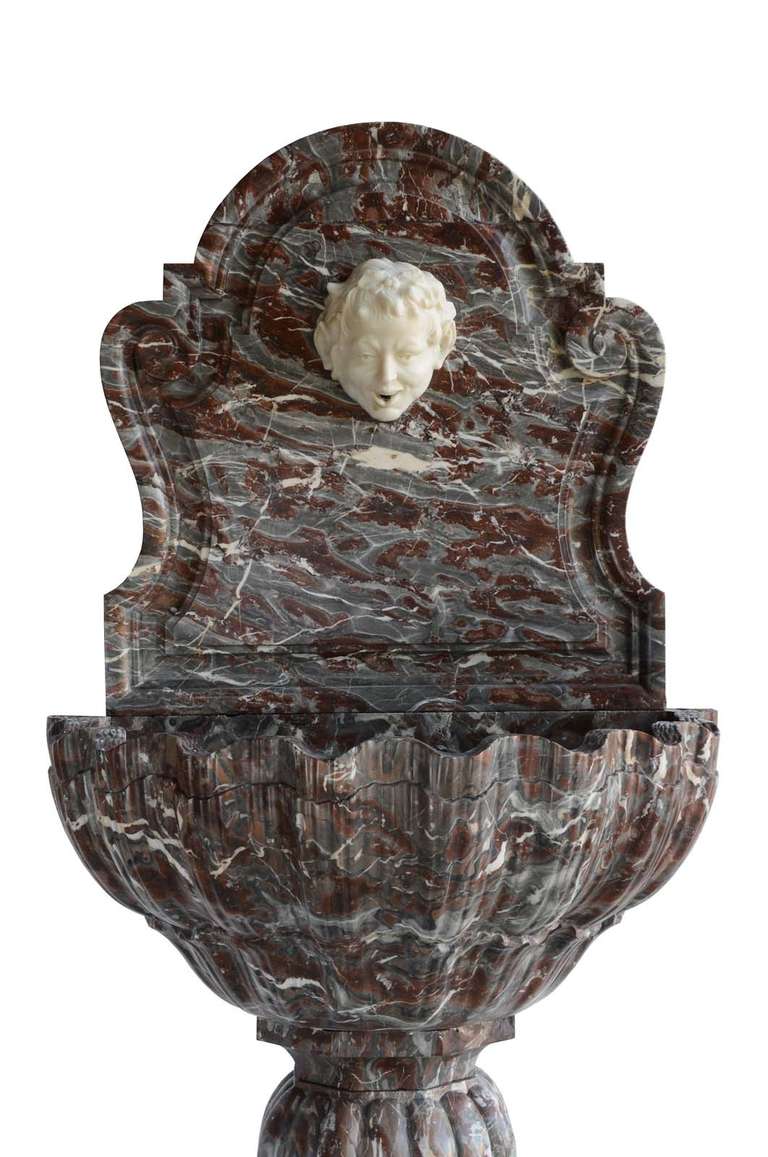 French Louis XIV style red marble wall fountain dated late 19th century.