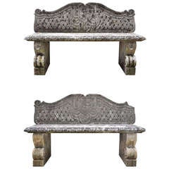 Pair of stone garden benches dated late 19th century.