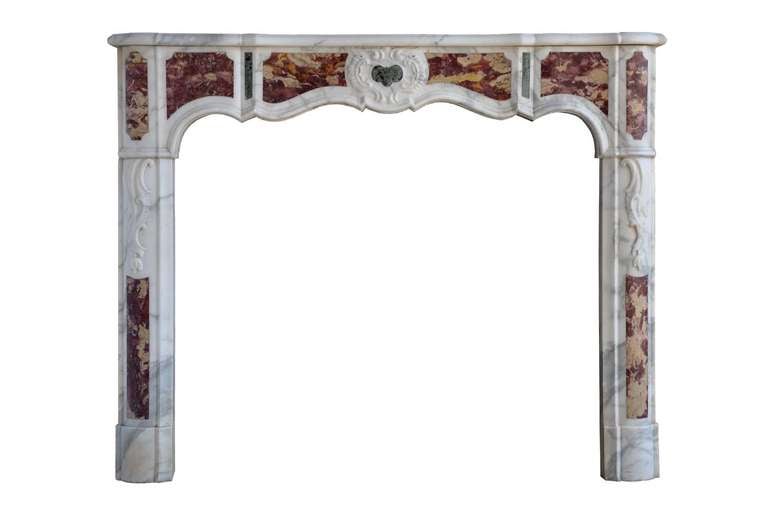 A French Régence period white marble with green and pink marble inserts fireplace, early 18th century. Measures: Opening 36 in. H. x 41 in. W. # C3351.