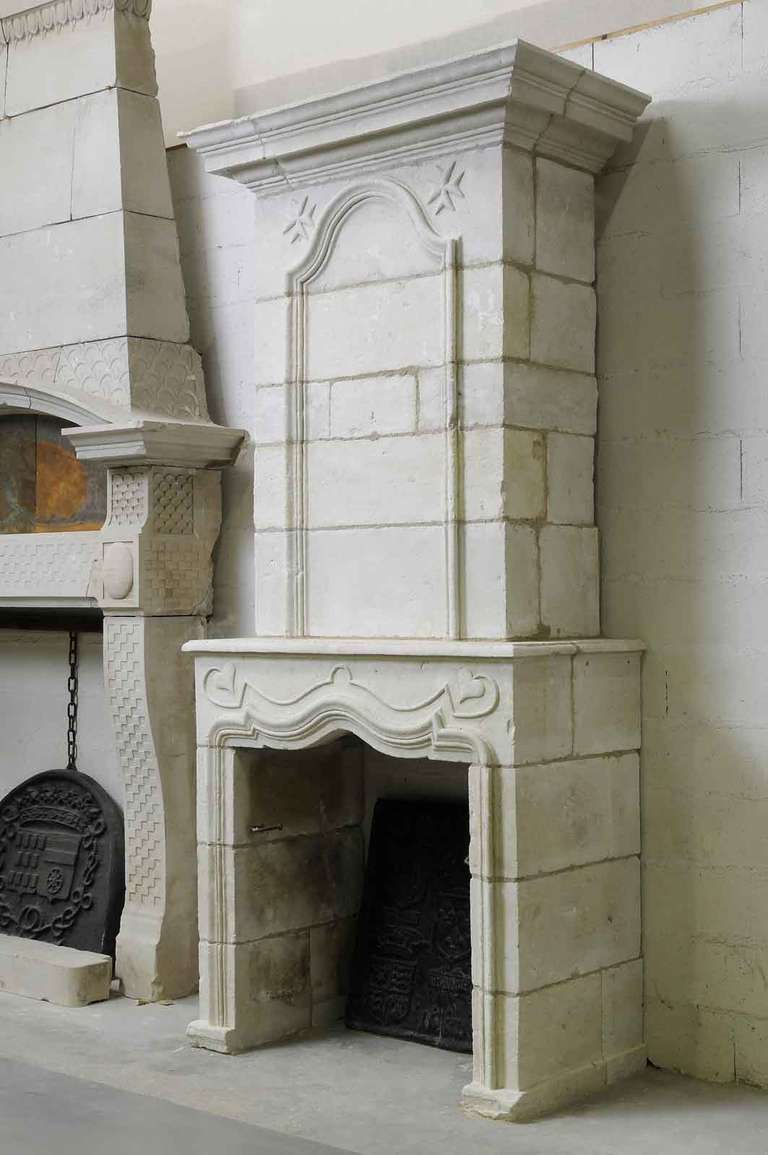 A French Louis the 14th period limestone fireplace dated early 18th century. Opening: 37 in. H. x 35 in. W. # C2917.