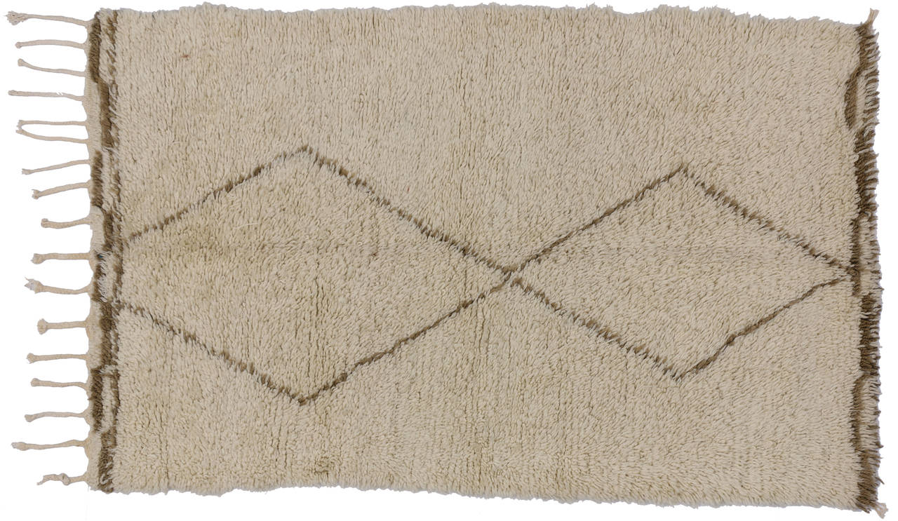 With its well defined lines and open space, this Berber Moroccan rug is believed to protect the human spirit from negative energy and shield the human body from the elements. Beni Ouarain (Beni Ourain) rugs are prized for their exciting, abstract