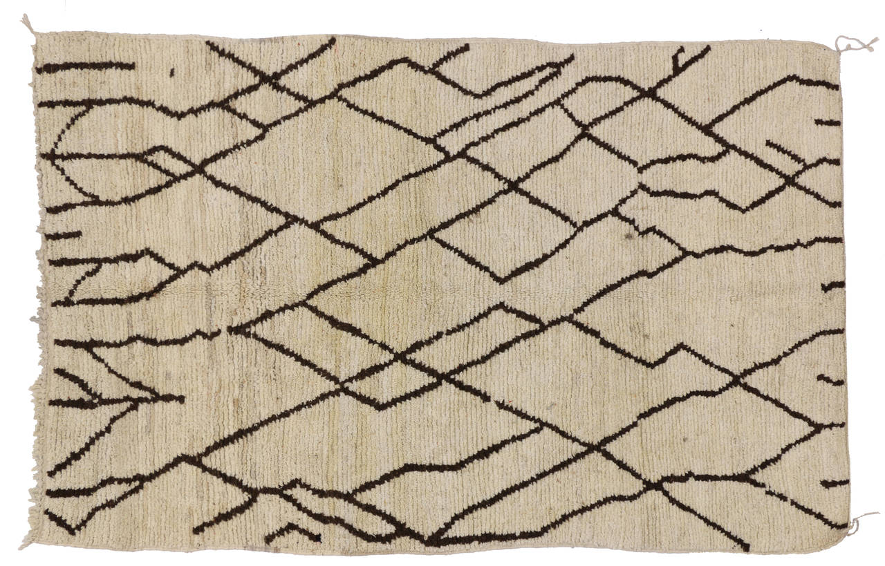 With its well defined lines and abstract trellis design pattern, this Berber Moroccan rug is believed to protect the human spirit from negative energy and shield the human body from the elements. Moroccan rugs are prized for their exciting, abstract