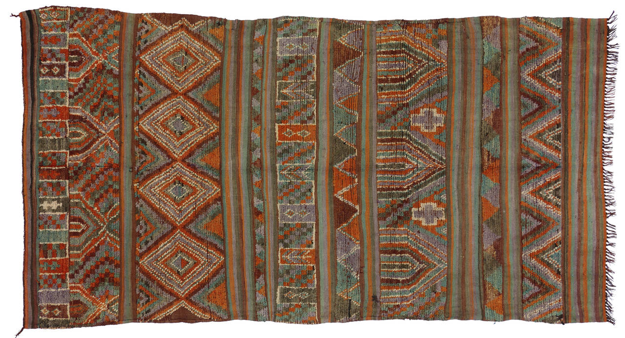 With a fondness for Moroccan flair, interior designers truly love the graphic punch and saturated color of Kilim rugs. The rich colors and graphic patterns in this vintage Kilim from Morocco pair well with modern décor. Using a mixed technique of