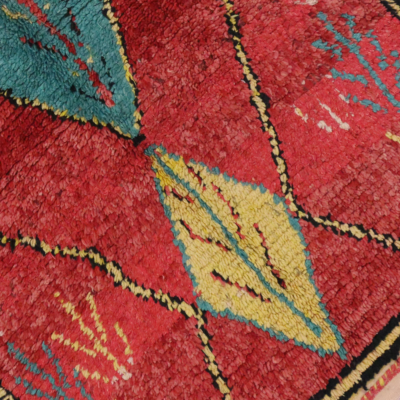 Moroccan rugs are known for their robust sense of geometric structure and colorful compositions making them a favorite among interior designers and savvy homeowners. The free-form designs in this vintage Moroccan rug synthesize beautifully with