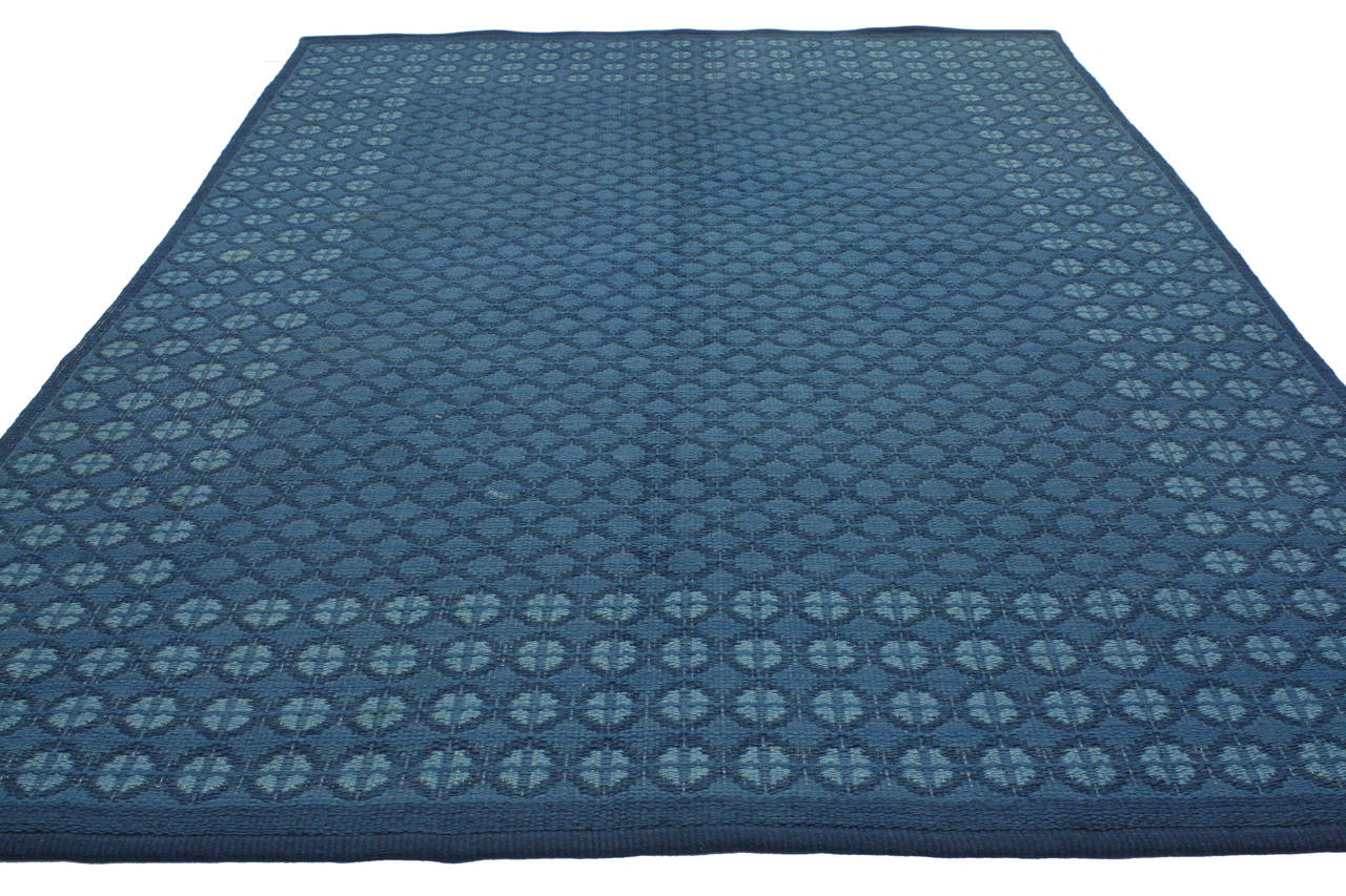 Featuring a traditional modern design highlighting some of the finest Mid-Century Swedish rugs, this appealing example is influenced by its subtle beauty that is enhanced by its idyllic shades of blue and all-over repetitive geometric motifs. This
