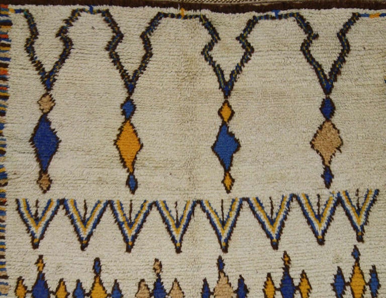 Simply ravishing! Morocco's rural weaving culture has attracted a great deal of attention from the international art world over the past 20 years. With its decorative motifs and colorful accents, this beautiful Berber Moroccan rug is believed to