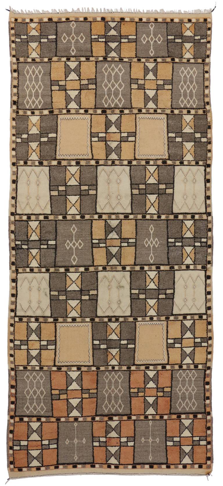 A very rare and unique vintage Moroccan rug from the southern Jebel Siroua region in the High Atlas of Morocco. It features a special high-low pile which adds depth with its distinctive detailing. With the Zenaga region palette of greys, oranges,