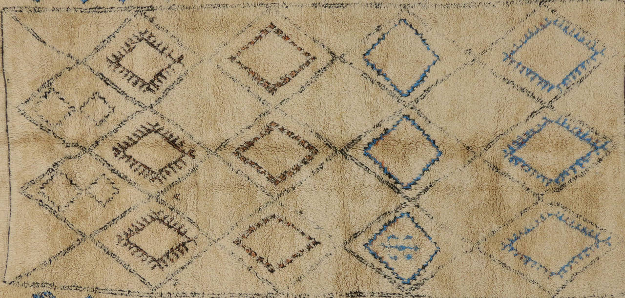 Beautiful soft pile handmade from the weaver’s imagination, the colors and diamond motifs chosen as expressions of Moroccan tribal tradition. This tranquil vintage Beni Ourain Moroccan rug with tribal boho chic style features a diverse variety of