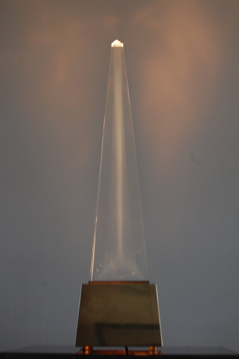 Rare Lucite and Brass Obelisk Lamp by Chapman. Obelisk can simply be an object or it can be illuminated and used as a lamp. Dimmer switch to rear of hand crafted brass base.

We offer free delivery within the Long Island / Greater NYC,
northern