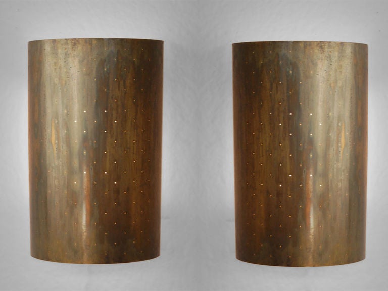 Pair of large scale, solid brass modern sconces with perforated faces. Each sconce having 4 porcelain sockets. Whether lit or not, these large sconces are very dramatic. Quality is that of Paavo Tynell / Taito oy, but we feel that they are American,