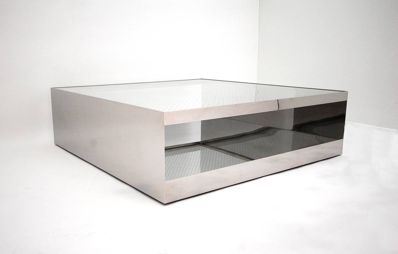 Ingenious polished stainless steel low table with safety glass top, designed by Joe D'urso for Knoll International, circa 1980. Retains Knoll International label and is hand signed "D'urso." (Joe D'Urso has confirmed that this is in fact